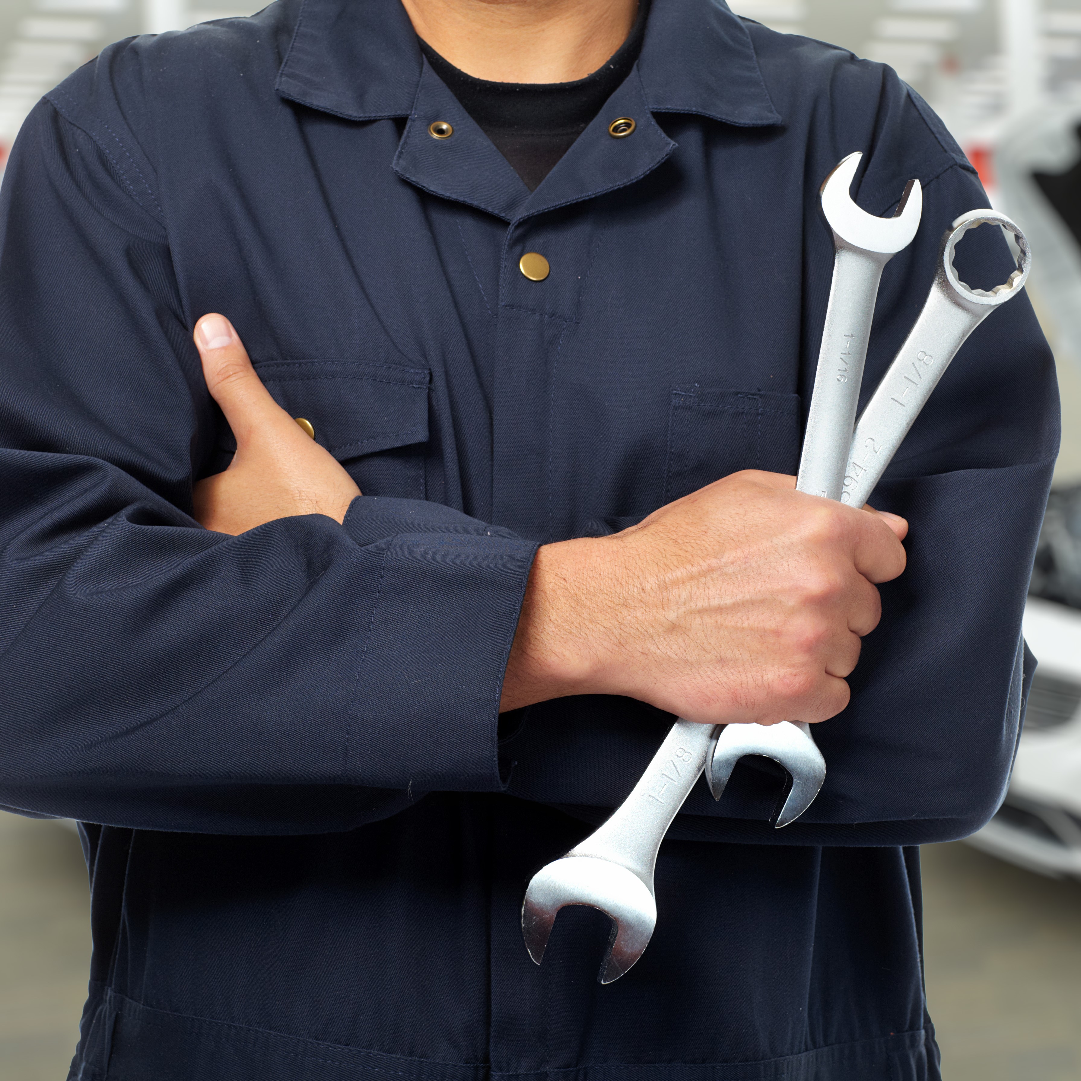 man holding wrenches